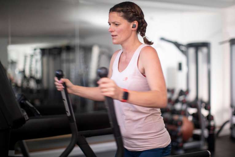 Lady in the gym on running machine