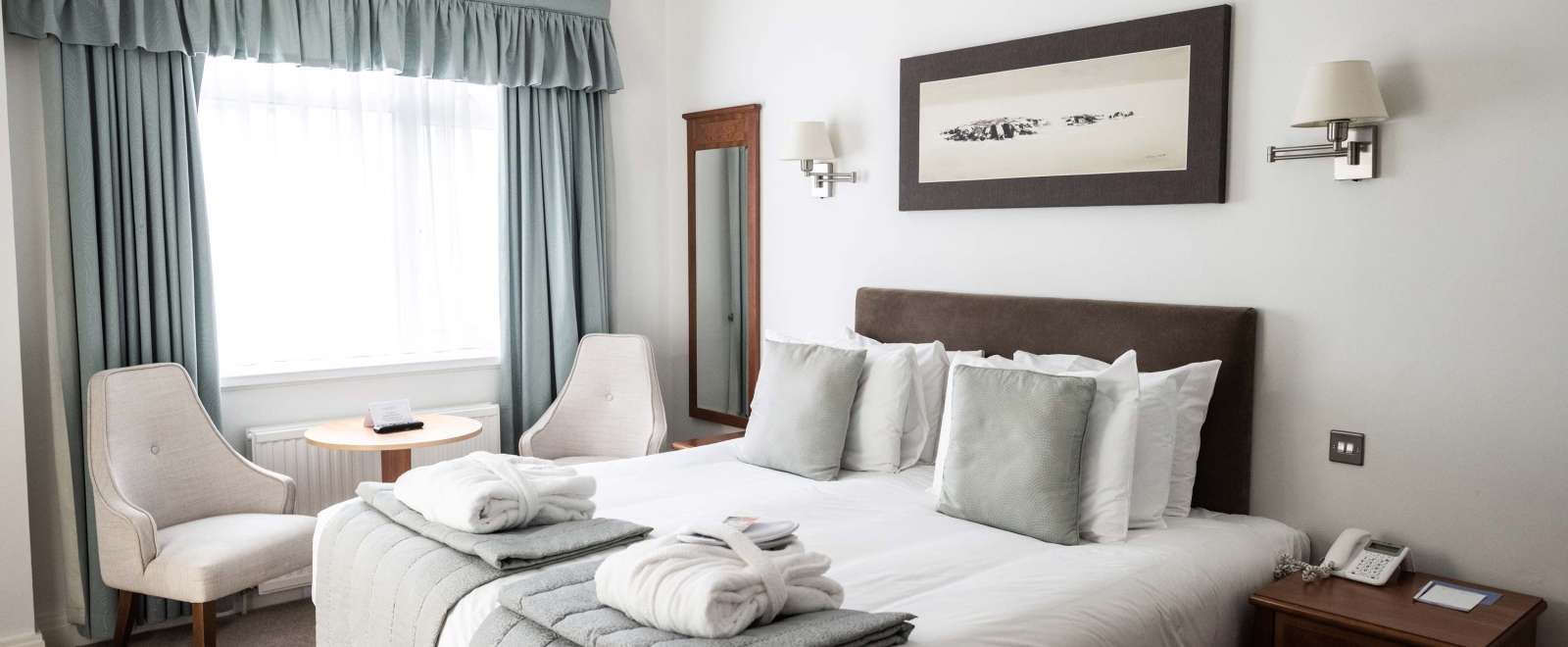 Saunton Sands Hotel Cosy Room Accommodation Bedroom with Seating Area and Dressing Gowns on Bed