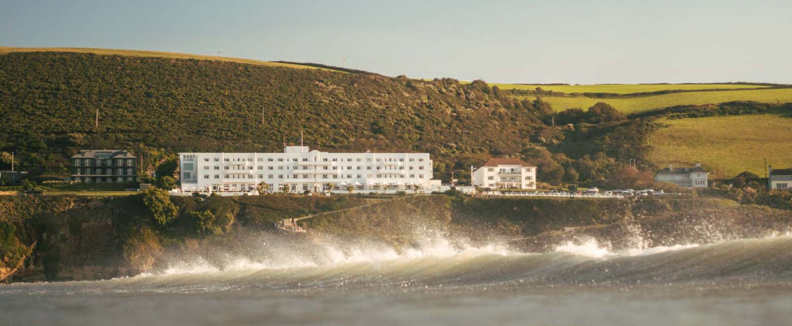 Saunton Sands Hotel Exterior View from Sea with Crashing Wave