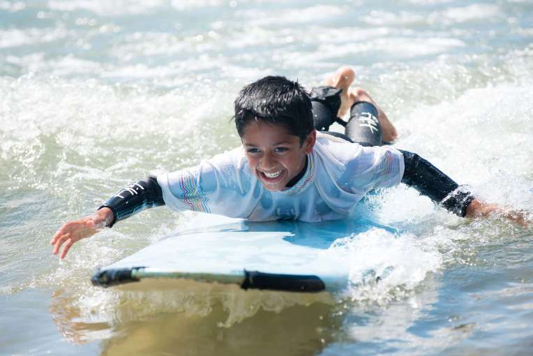 Saunton Sands Hotel Child Guest Learning to Surf in Sea on Saunton Beach