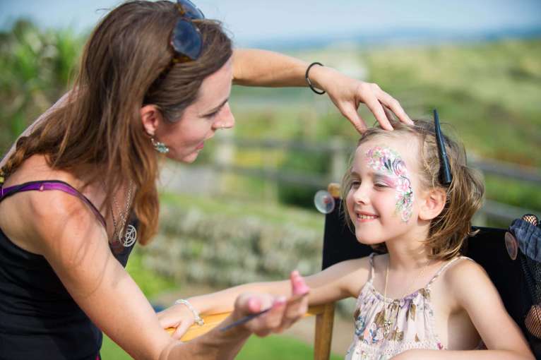 Saunton Sands Hotel Face Painter Working on Girl on Lawn