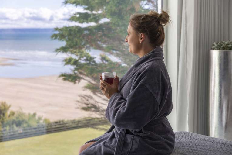 Saunton Sands Hotel Source Spa Guest Enjoying View from Treatment Room with a Drink