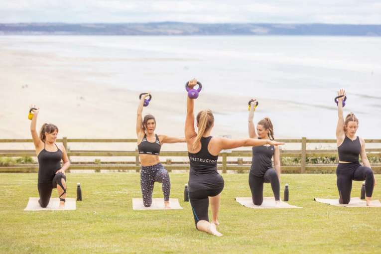 Fitness class on lawn with sea views