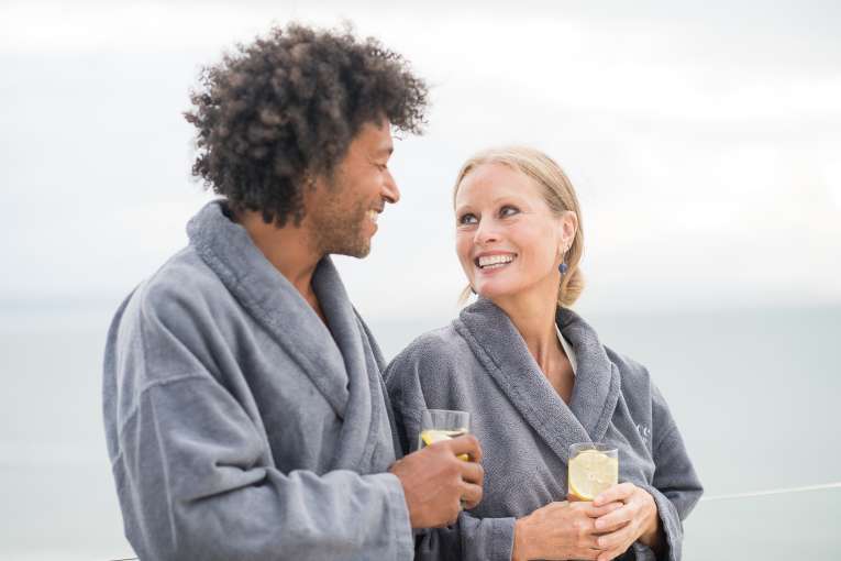 Couple on a spa break looking at each other 