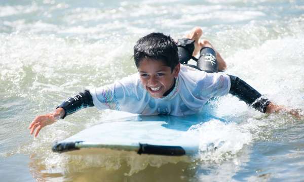 Saunton Sands Hotel Child Guest Learning to Surf in Sea on Saunton Beach