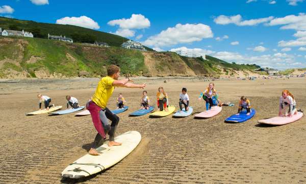 Saunton Sands Hotel Saunton Beach Surf Instructor Teaching Children with Hotel in Background