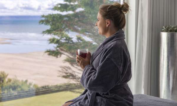 Saunton Sands Hotel Source Spa Guest Enjoying View from Treatment Room with a Drink