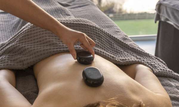 Saunton Sands Hotel Source Spa Guest Receiving Hot Stone Massage in Treatment Room