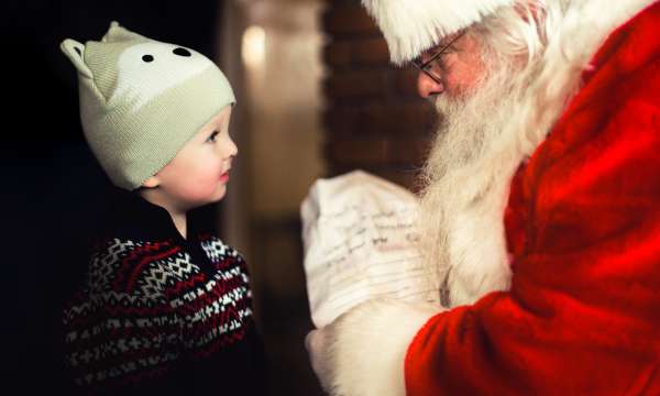 Little boy looking at father christmas