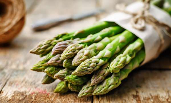Bunch of green asparagus on a wooden table
