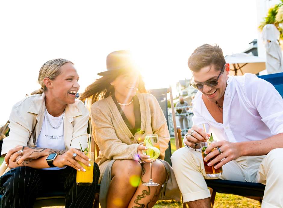 Three friends happy with a sunset
