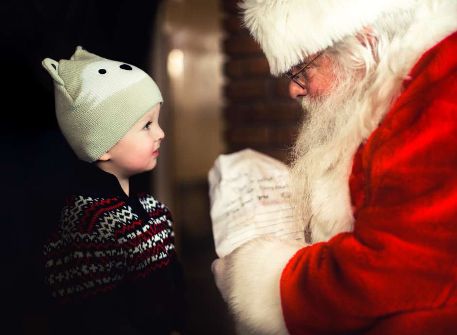 Little boy looking at father christmas