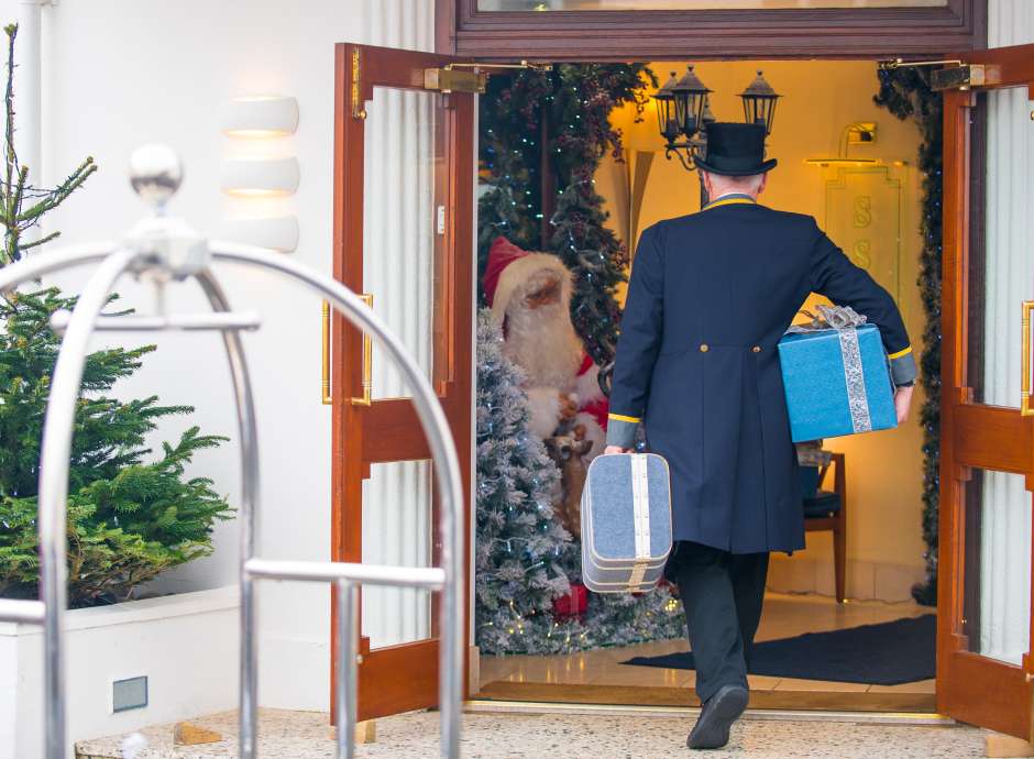Doorman walking into festive hotel 