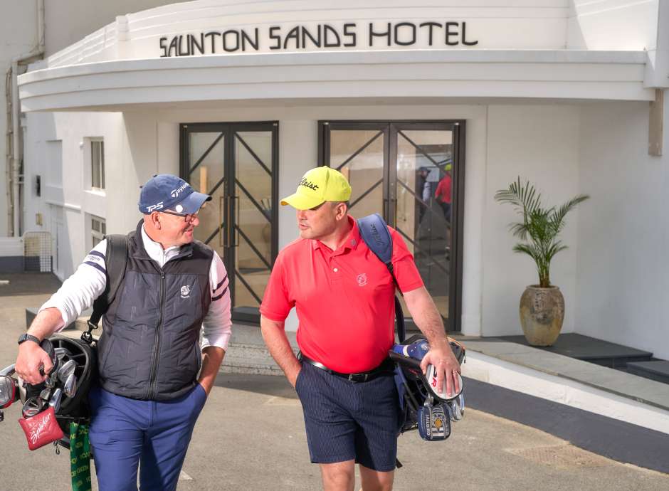 2 men outside with their golfing kit