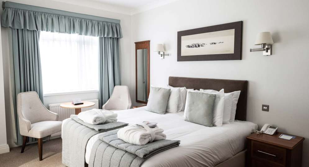 Saunton Sands Hotel Cosy Room Accommodation Bedroom with Seating Area and Dressing Gowns on Bed