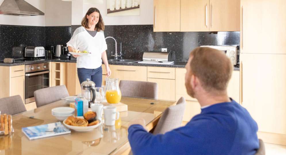 Couple eating breakfast in Hartland Apartment's kitchen