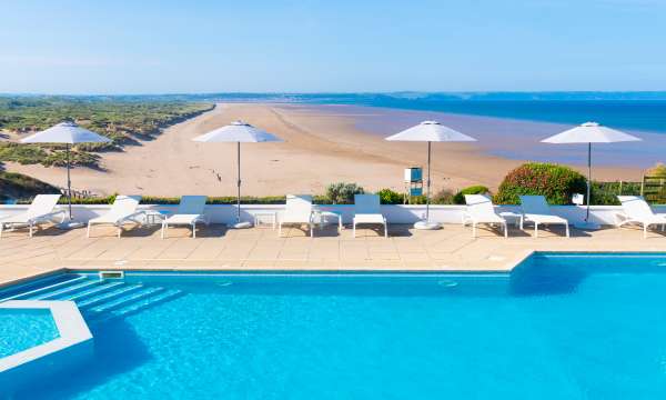 Outdoor swimming pool with brollies up 