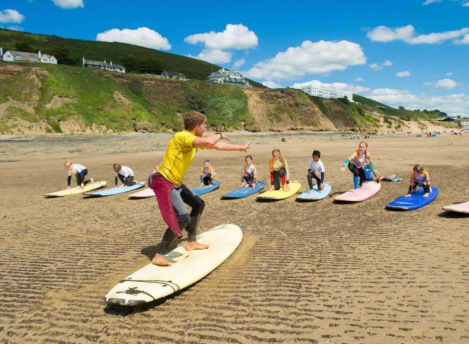 Saunton Sands Hotel Saunton Beach Surf Instructor Teaching Children with Hotel in Background