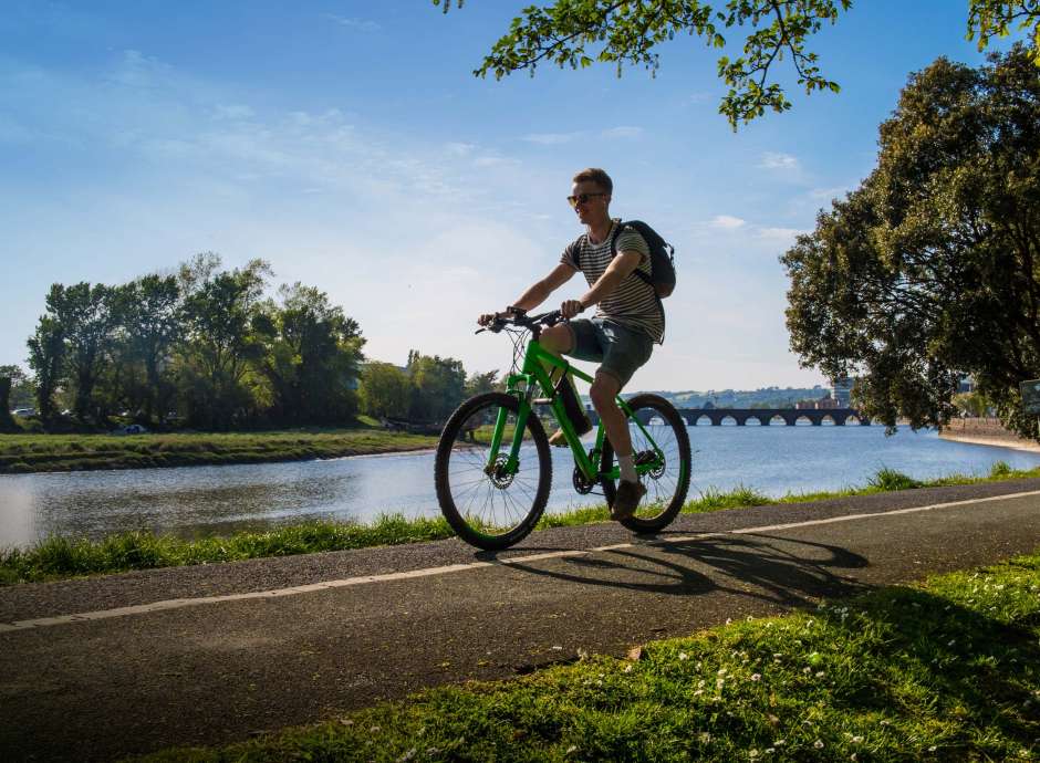 Cyclist on Tarka Trail in Rock Park Barnstaple North Devon