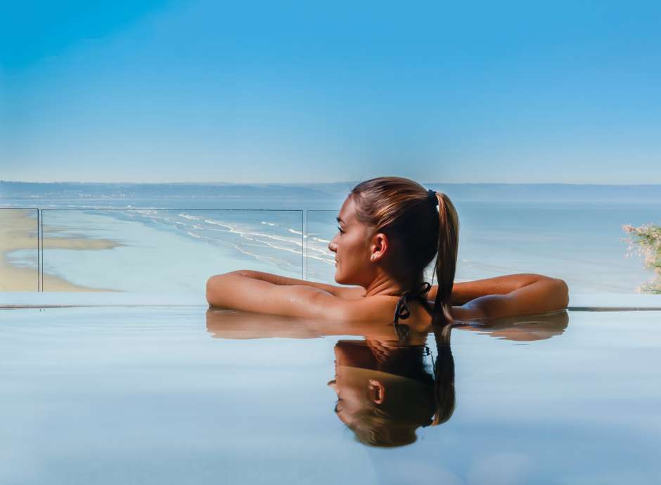 Saunton Sands Hotel Source Spa Guest in Vitality Pool Looking Out on Saunton Beach