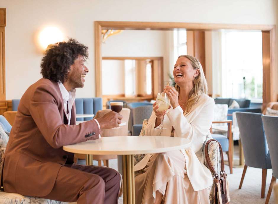 Couple in cocktail bar with drinks