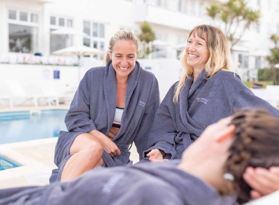 Group of women relaxing by the outdoor pool