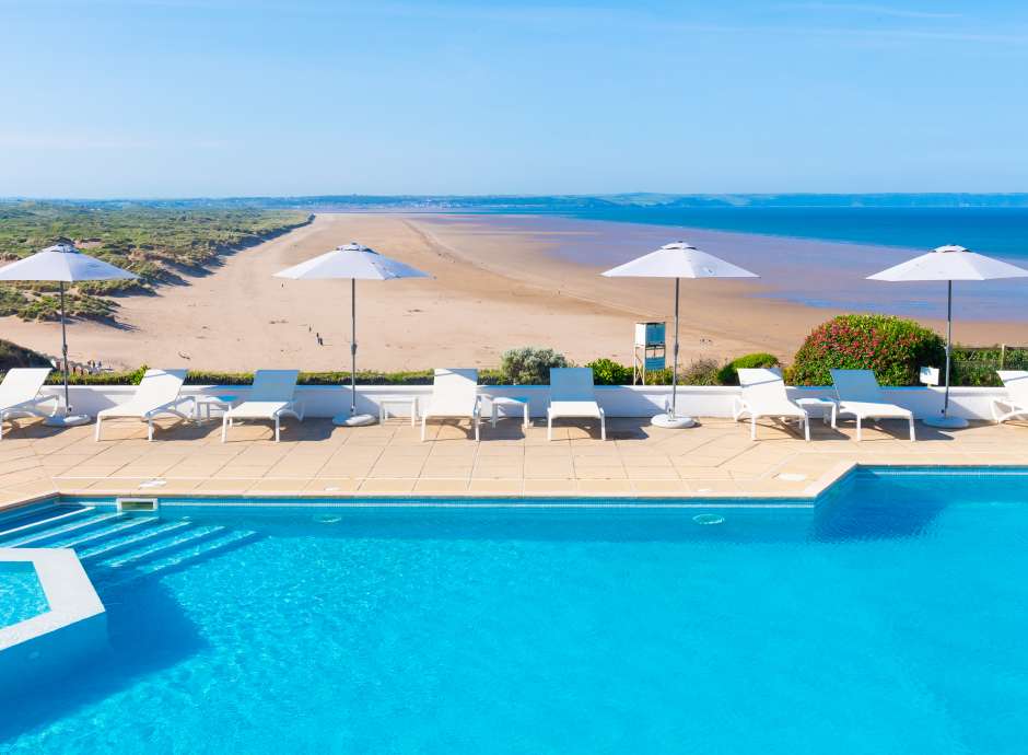 Outdoor swimming pool with brollies up 